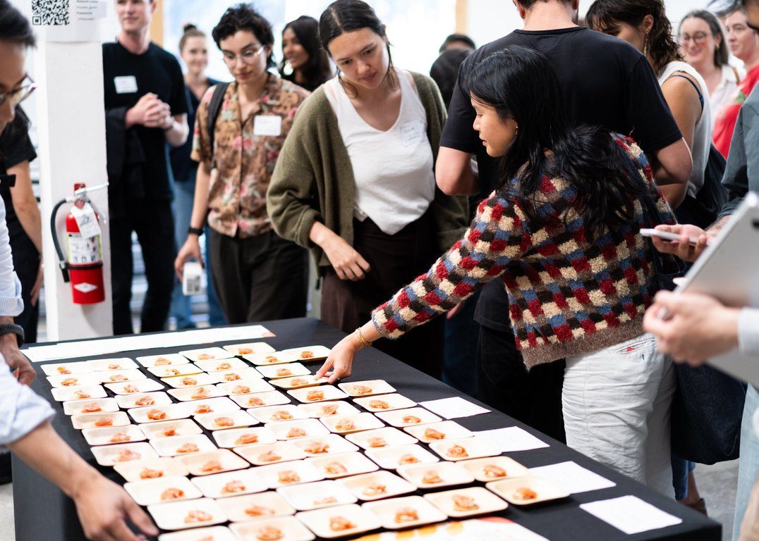 Guests choosing plates of Wildtype’s cultivated salmon after the Pioneers talk